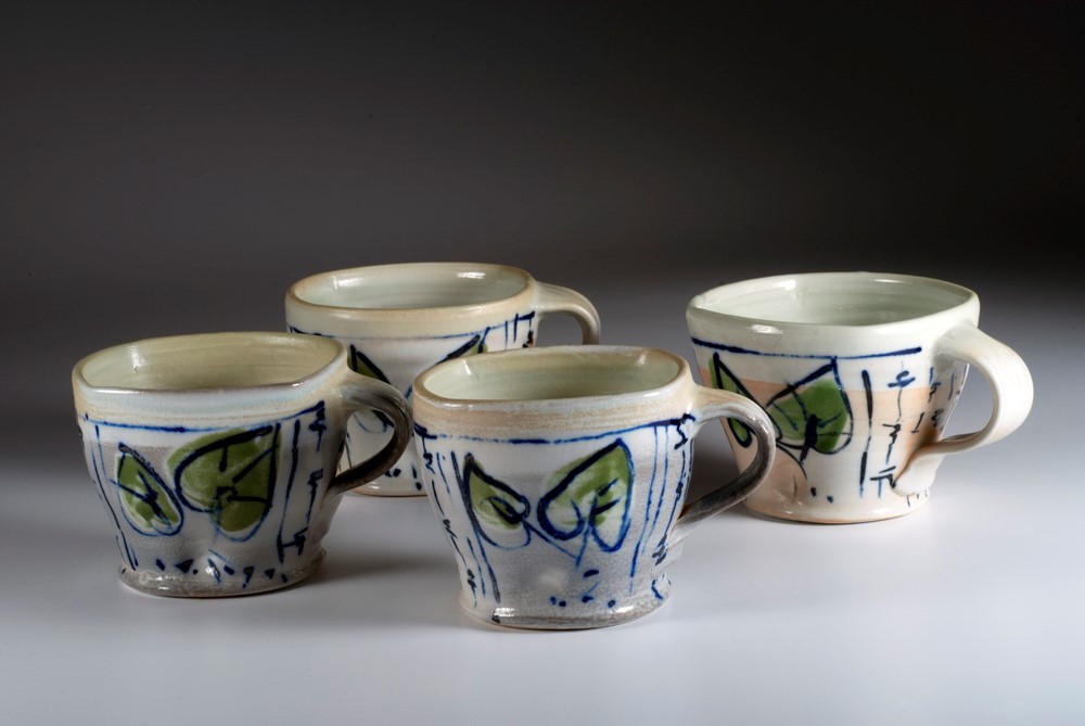 Barbara Tipton. 2014. Latte cups, wheel thrown porcelain, 10 cm high, brush decoration with cobalt/manganese stain, green glaze, wood/soda firing.