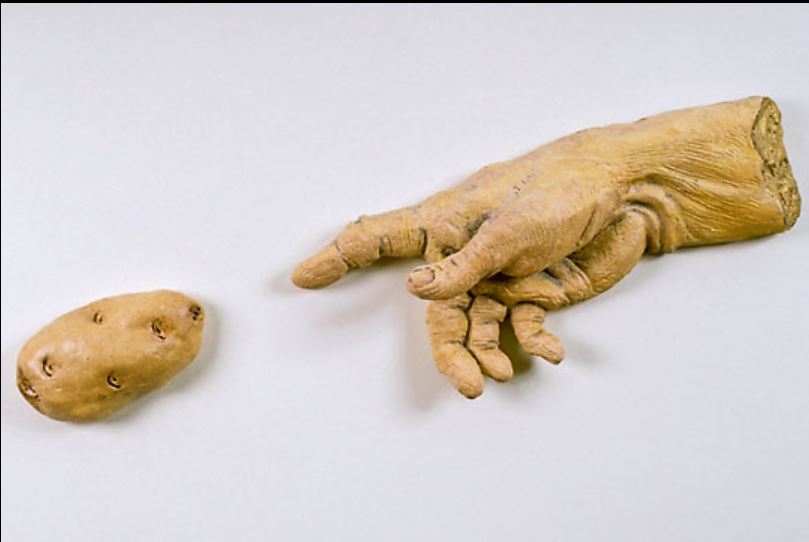 Victor Cicansky. The Creation of the Potato. Clay, glaze, wood backing. 41.9 x 74.9 x 8.9 cm. 1993